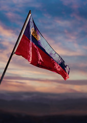 Liechtenstein flag, Liechtenstein flag waving on sky at dusk