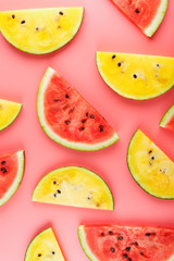 Slices of red and yellow watermelon on a pink background in the form. Minimal food concept idea