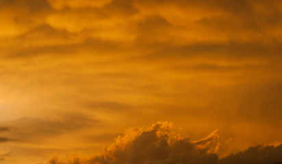 Strange and mysterious sunset sky with golden clouds as alien planet atmosphere background