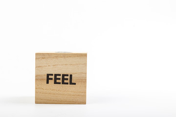 Wooden cubes with the inscription feel on a white background