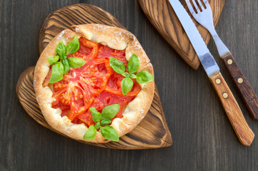 red tomato pie on a wooden Board.
