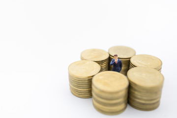 Business, Money, Finance and management concept. Close up of businessman miniature figure standing center of row of stack of gold coins on white background and copy space.