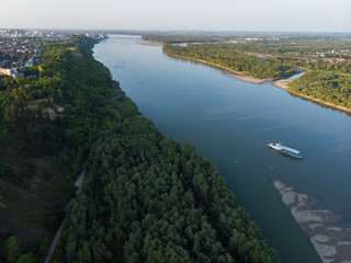 Aerial view of big siberian Ob river and ship, summer day, drone shot