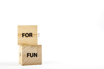 Wooden cubes with the inscription for fun on a white background close up