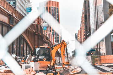 Construction scene in New York City. Excavator and several tools of construction. Edited with...