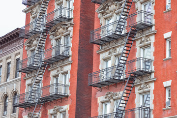 Red brick facade, and fire stairs. Harlem, NYC.
