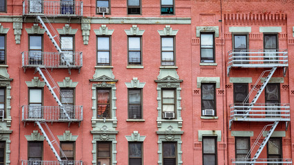 Red brick facade, and fire stairs. Harlem, NYC.