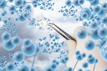 The laboratory worker with tweezers takes a molecule .