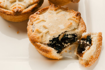 Snowflake decorated mince pie with icing sugar on the top