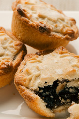 Small pile of blueberry pies on white plate