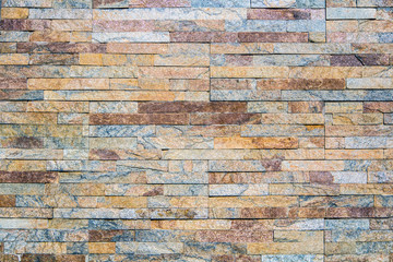 Decorative texture of a beautiful wall with rectangular parts of multi-colored artificial stone...