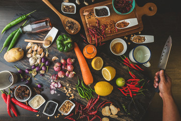 Healthy food herbs Spices for use as cooking ingredients on a wooden background with Fresh organic vegetables on wood. The concept of food ingredients with Variety on the rustic table.