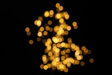 Bokeh lights on the black background unfocused.