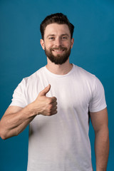 happiness, gesture and people concept - smiling man showing thumbs up. Portrait of a handsome man.