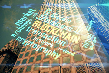 Multi exposure of cryptocurrency theme hologram drawing and city veiw background. Concept of blockchain and bitcoin.