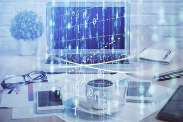 Double exposure of table with computer on background and data theme hologram. Data technology concept.