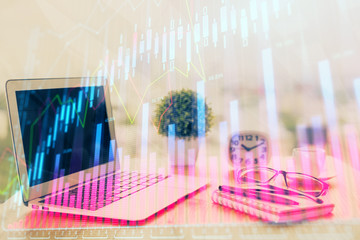 Stock market graph on background with desk and personal computer. Double exposure. Concept of financial analysis.