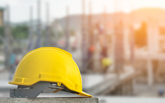 yellow hard safety wear helmet hat in the project at construction site
