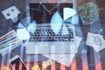 Financial graph colorful drawing and table with computer on background. Multi exposure. Concept of international markets.