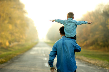 father and son walk in nature - obrazy, fototapety, plakaty