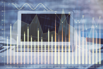 Financial chart drawing and table with computer on background. Double exposure. Concept of international markets.