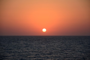 Sunset at sea in tropical terrain