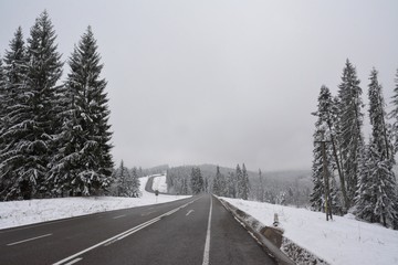 a road through mountains in winter