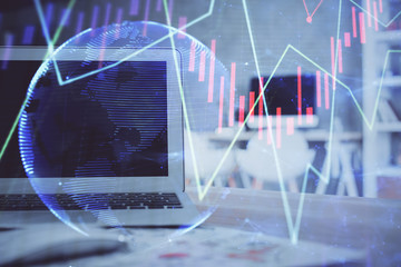 Stock market chart hologram drawn on personal computer background. Double exposure. Concept of investment.