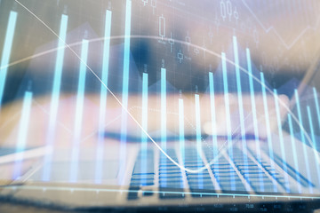 Financial chart drawing and table with computer on background. Double exposure. Concept of international markets.
