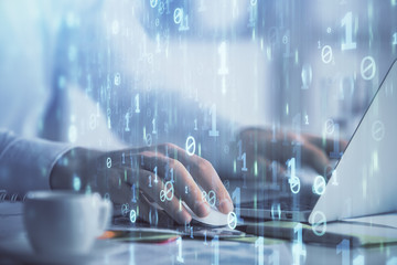 Businessman with computer background with technology theme hologram. Concept of hightech. Multi exposure.