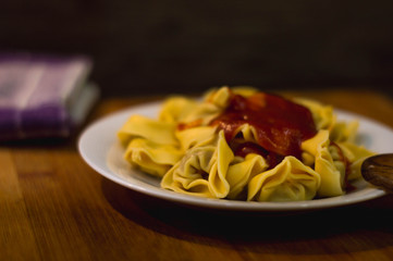 Plate of meat ravioli with tomato