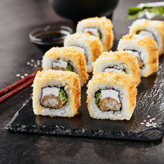 Macro shot of hot crispy ebi tempura maki sushi rolls with cream cheese, king prawn, chuka kelp...