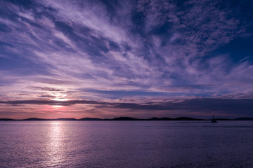 sunset over the sea, cirrus and cirrostratus clouds