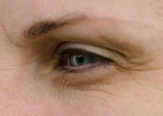 Obraz premium Woman face with blue eye in detail