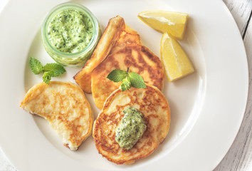 Portion of ricotta fritters with mint sauce