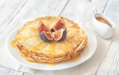Stack of crepes on the white plate