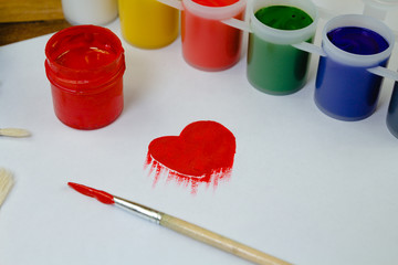 Painting in shape of heart created with gouache on paper in workshop