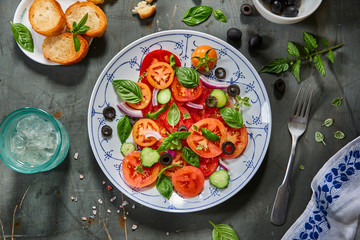 Salad of tomatoes, cucumbers, green peppers, olives, onions with