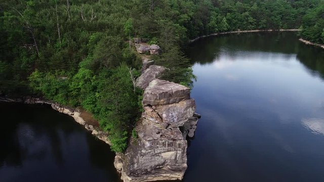 Tilt down aerial, cliff in Laurel River Lake