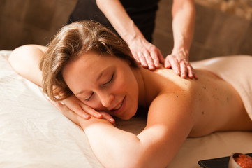 Obraz na płótnie Canvas Beautiful young woman receiving a massage.