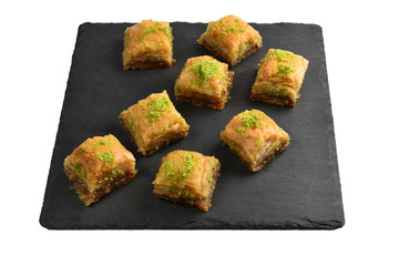 Pistachio baklava on a black plate. Dessert.