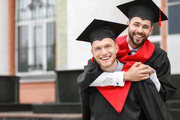 Young students in bachelor robes outdoors