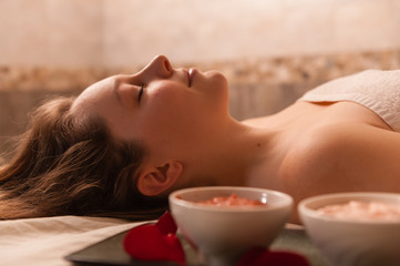 Obraz na płótnie Canvas Beautiful woman receiving a massage in a spa.