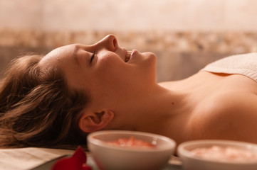 Obraz na płótnie Canvas Beautiful woman receiving a massage in a spa.