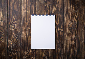 Empty open notebook on wooden background