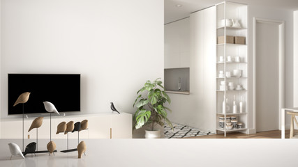 White table top or shelf with minimalistic bird ornament, birdie knick - knack over blurred contemporary white and wooden living room with kitchen, modern interior design