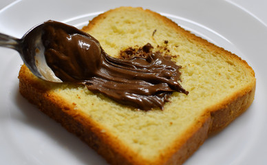 Chocolate cream spread on a toast bread loaf
