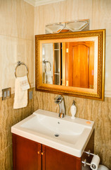 Hands wash basin with the mirror in a bathroom of luxury house