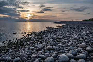 stones on beach at sunset