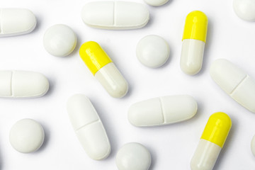 group of pills, yellow capsules on white background